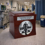 Wooden cremation urn with doctor engraving, placed in a hospital environment.