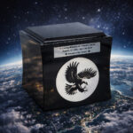 Black cremation urn with engraved eagle design, set above Earth with a starry sky background.