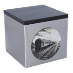 Rechtwinklige Ansicht der Urne mit Eisenbahnmotiv, gebürsteter Stahlkasten mit Zuggrafik.