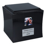 Black wooden cremation urn with photo and memorial plaque