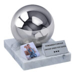 Stainless steel spherical child urn on marble base with memorial plaque and photo tile