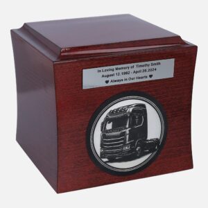 Wooden cremation urn with engraved truck and memorial plaque, front view.