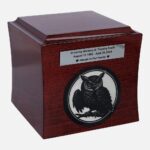 Wooden cremation urn with engraved owl and memorial plaque, front view.