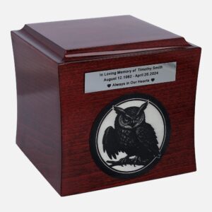 Wooden cremation urn with engraved owl and memorial plaque, front view.