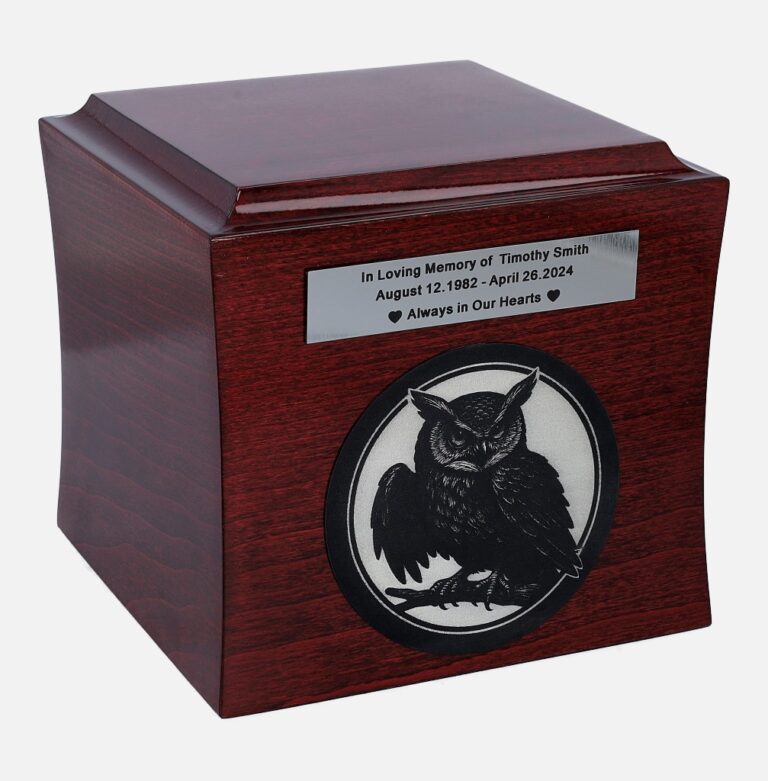 Wooden cremation urn with engraved owl and memorial plaque, front view.