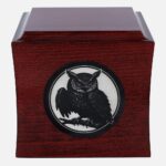 Cremation urn with owl engraving, front view.