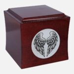 Modern wooden urn with angel wings motif, rounded-edge profile, side angle.