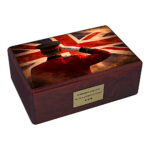Wooden cremation urn with British soldier salute and Union Jack flag design isolated on white background
