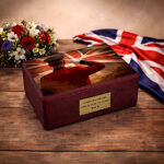 British patriotic urn on rustic wooden table with flowers and Union Jack backdrop