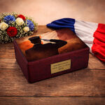 French patriotic urn on rustic wooden table with flowers and French flag backdrop