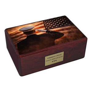 Wooden cremation urn with American flag and saluting soldier design isolated on white background