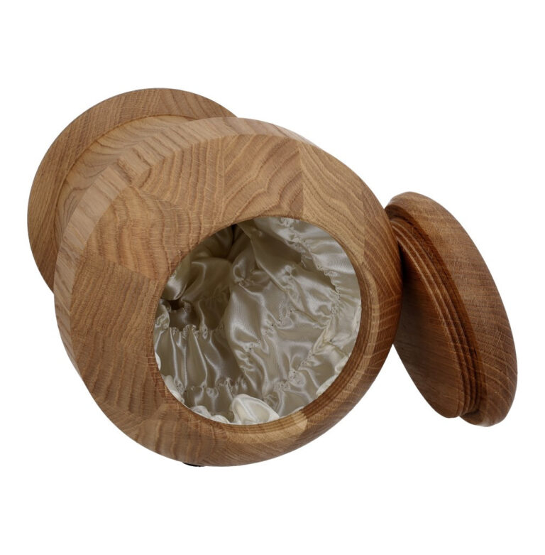 Solid oak cremation urn with soft fabric-lined interior.